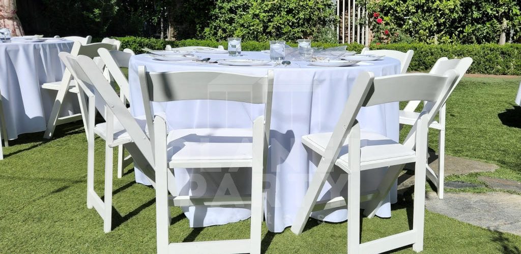 White Wooden Chairs with Round Table and Round White Tablecloth